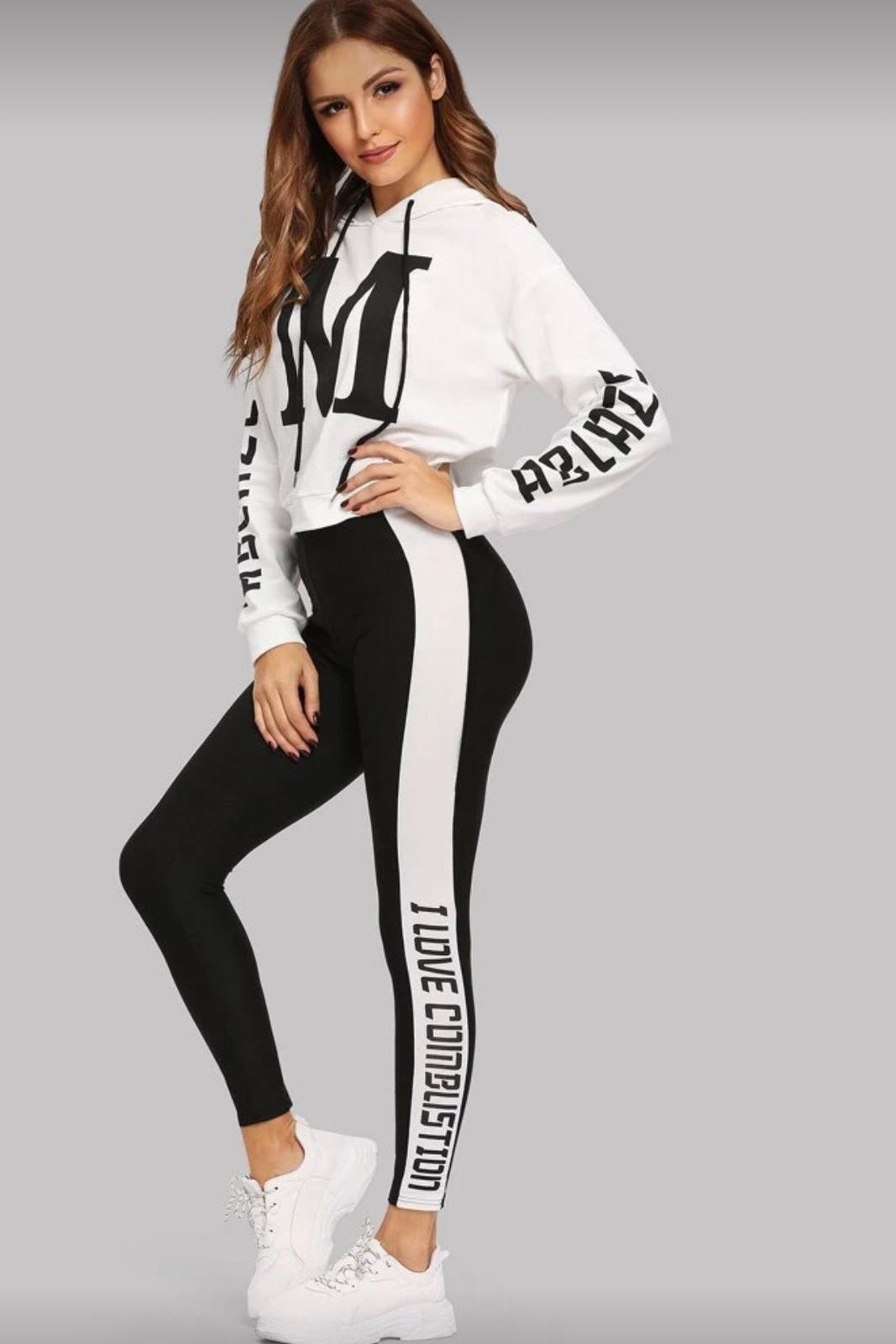 Woman wearing a white long-sleeve top and black leggings with text on a gray background